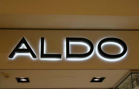 Reverse lit channel letters with a halo glow on the wall behind, installed by Graphink in Miami